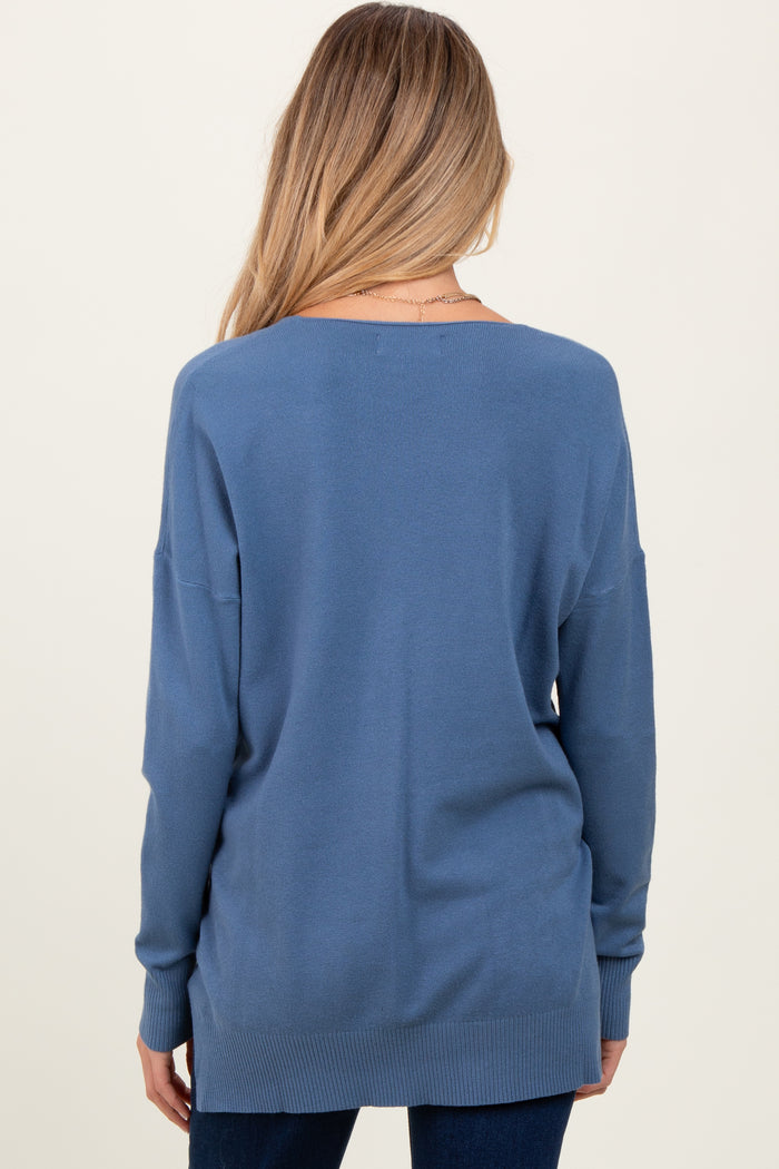 woman wearing a relaxed fit blue maternity sweater from the back with long sleeves and a dropped shoulder design