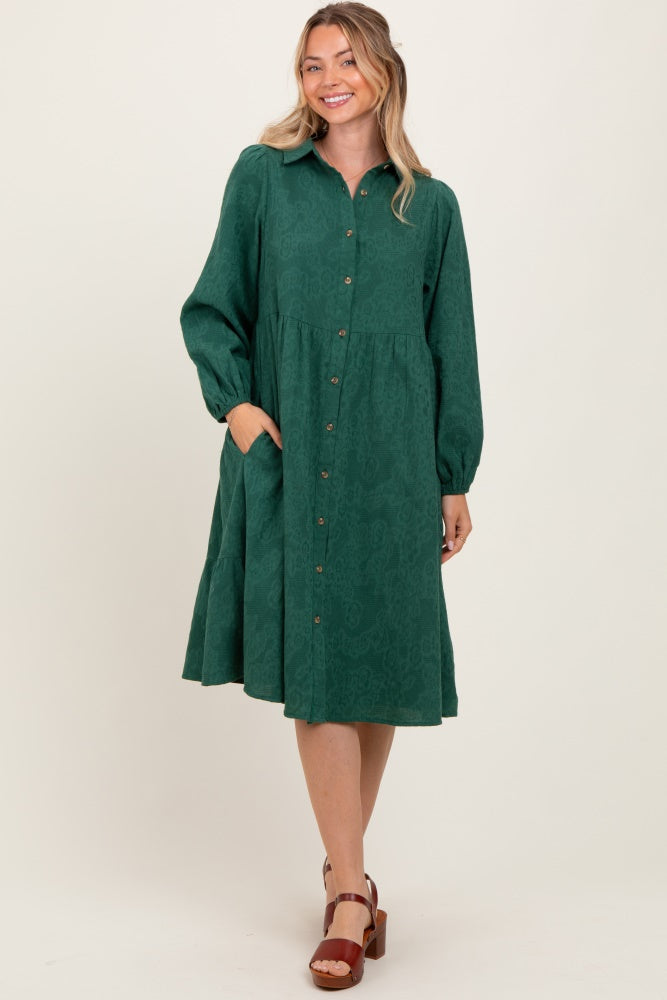 woman wearing a green long sleeve button-up dress with a flared skirt and pockets