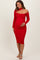 woman wearing a red off-the-shoulder maternity dress with a cut-out detail and holding her baby bump