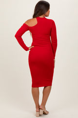 woman wearing a red long sleeve maternity dress with an open shoulder and a form-fitting silhouette
