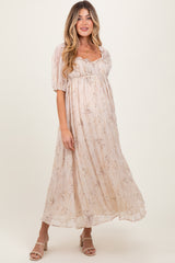 woman wearing a light floral maternity dress with short puff sleeves and a flowing silhouette