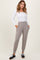 woman wearing a white long sleeve ribbed top and light beige jogger pants with pockets