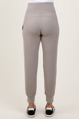 woman wearing light grey jogger pants with elastic waistband and cuffed ankles, shown from the back