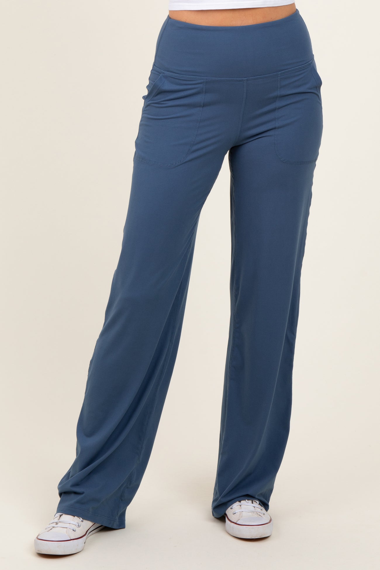 woman wearing blue wide-leg lounge pants with a high waistband and side pockets