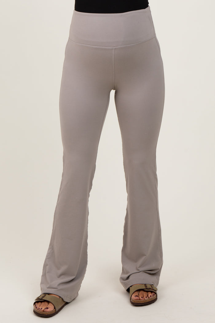woman wearing light gray maternity flare leggings with a wide waistband