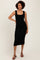 woman wearing a black ribbed midi dress with scalloped neckline and fitted silhouette