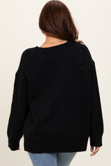 woman wearing a black oversized sweater from the back with long sleeves and a relaxed fit