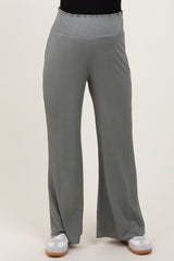 woman wearing light gray maternity wide-leg pants with a smocked waistband and ribbed texture