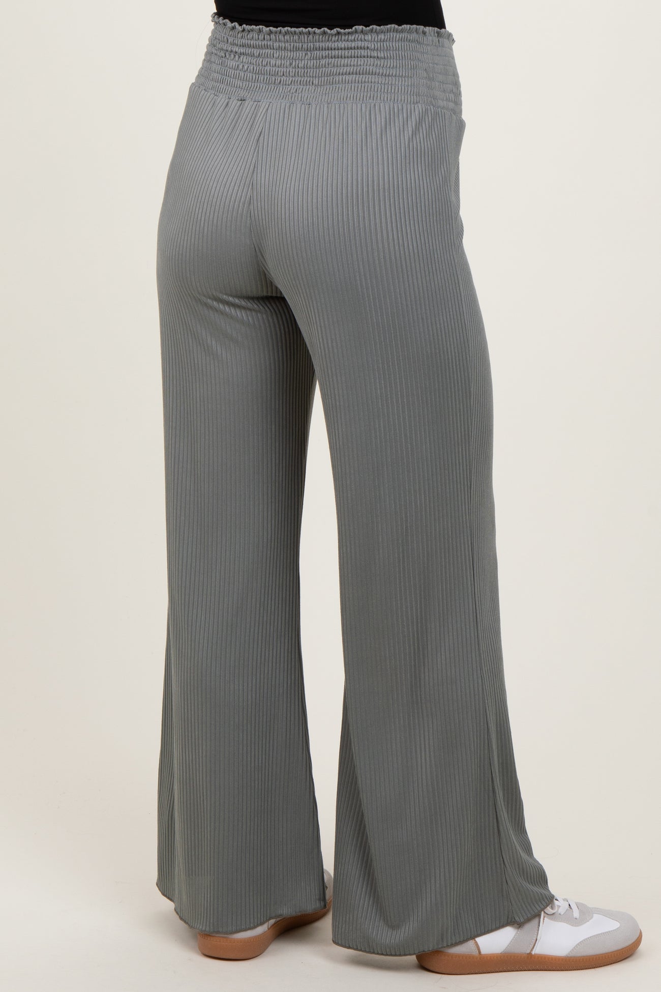 woman wearing light gray maternity wide-leg pants with a smocked waistband, view from the back