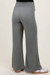 woman wearing light gray maternity wide-leg pants with a smocked waistband, view from the back