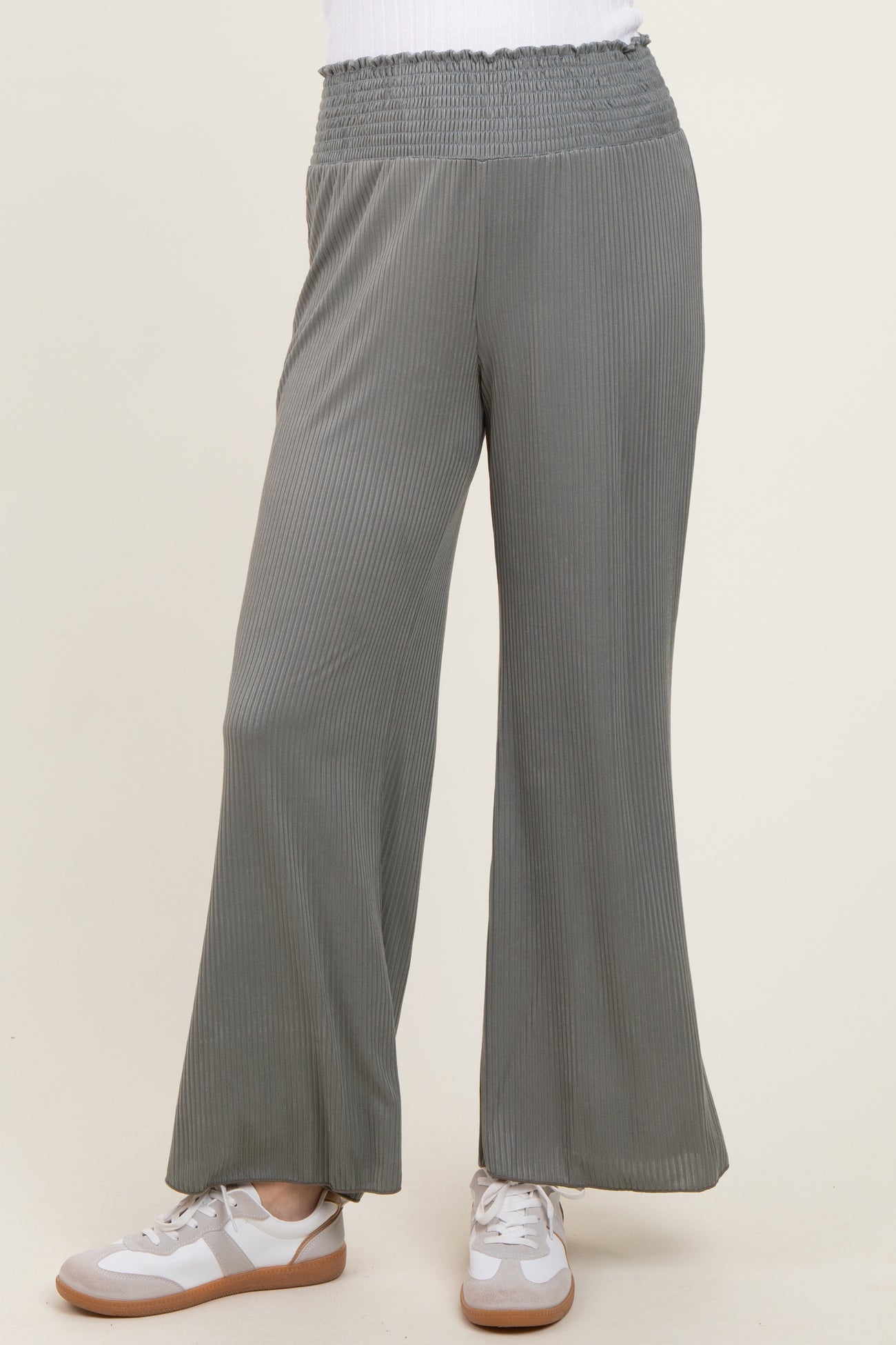 woman wearing gray ribbed wide-leg pants with an elastic waistband styled with white sneakers