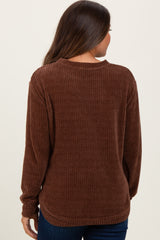 woman wearing a brown ribbed maternity sweater seen from the back