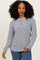 woman wearing a gray long sleeve waffle knit sweater paired with blue jeans