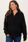 woman wearing a black maternity pullover sweater with half-zip and oversized fit, showcasing her baby bump