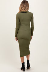 woman wearing an olive green ribbed long sleeve maternity dress, visible baby bump, back view