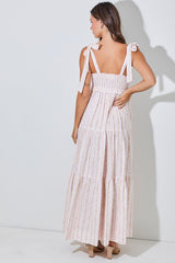 woman wearing a pink floral maxi dress with smocked back and tie straps, viewed from the back