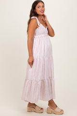 woman wearing a pink and white striped maternity maxi dress with adjustable straps and a baby bump visible