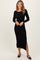 woman wearing a black ribbed long sleeve midi dress with a side slit and scalloped hem