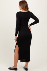 woman wearing a black ribbed midi dress with long sleeves and a side slit, shown from the back