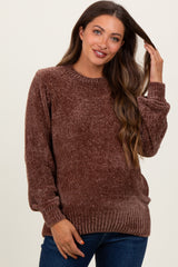 woman wearing a brown textured maternity sweater with long sleeves and a relaxed fit