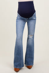 maternity wear blue flared jeans with a dark blue over-the-bump waistband and distressed detailing on the legs