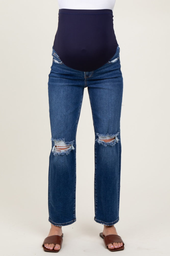 woman wearing dark blue maternity jeans with a distressed finish and a supportive belly panel