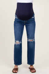 woman wearing dark blue maternity jeans with a distressed finish and a supportive belly panel