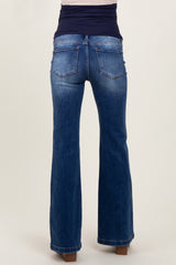 woman wearing dark blue bootcut maternity jeans, with a black belly band for support