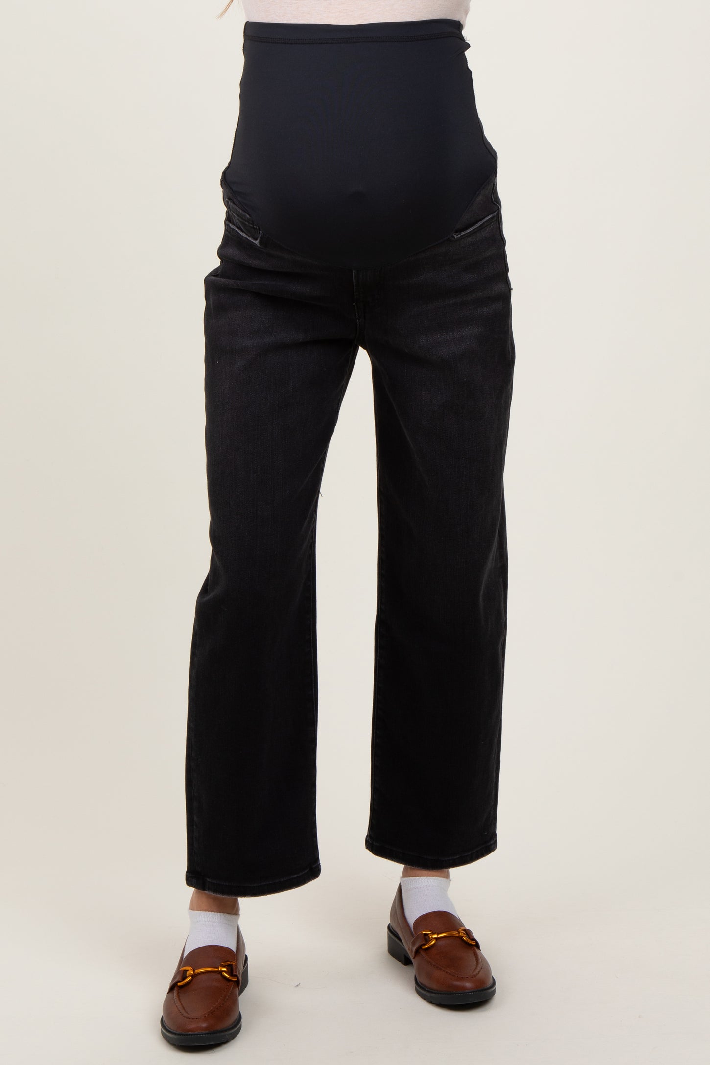 woman wearing black maternity jeans with a full belly band and relaxed fit