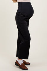 woman wearing black maternity jeans with a high waistband and a visible baby bump