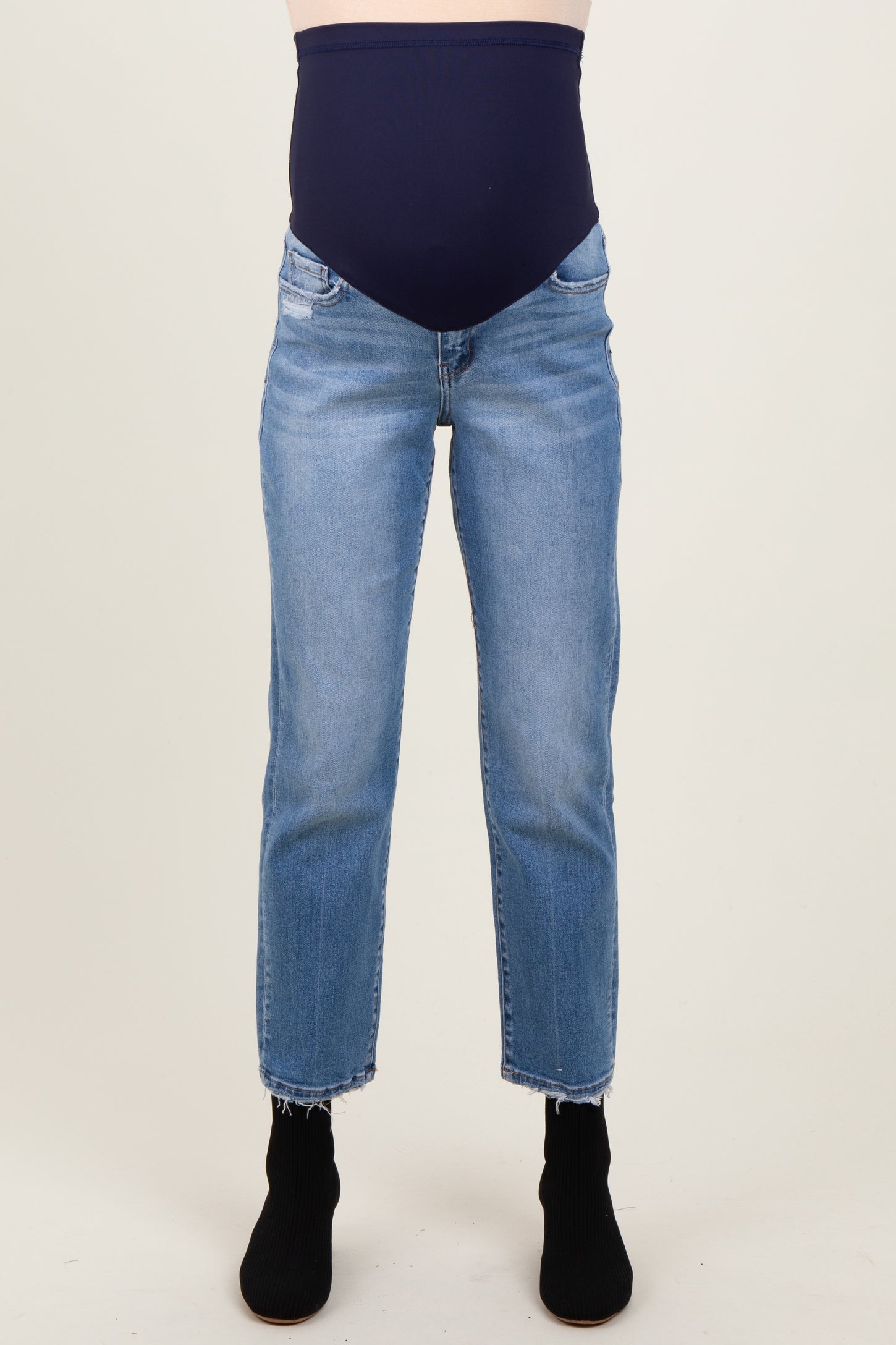 maternity wear blue skinny jeans with a thick navy belly panel, model wearing it with black ankle boots