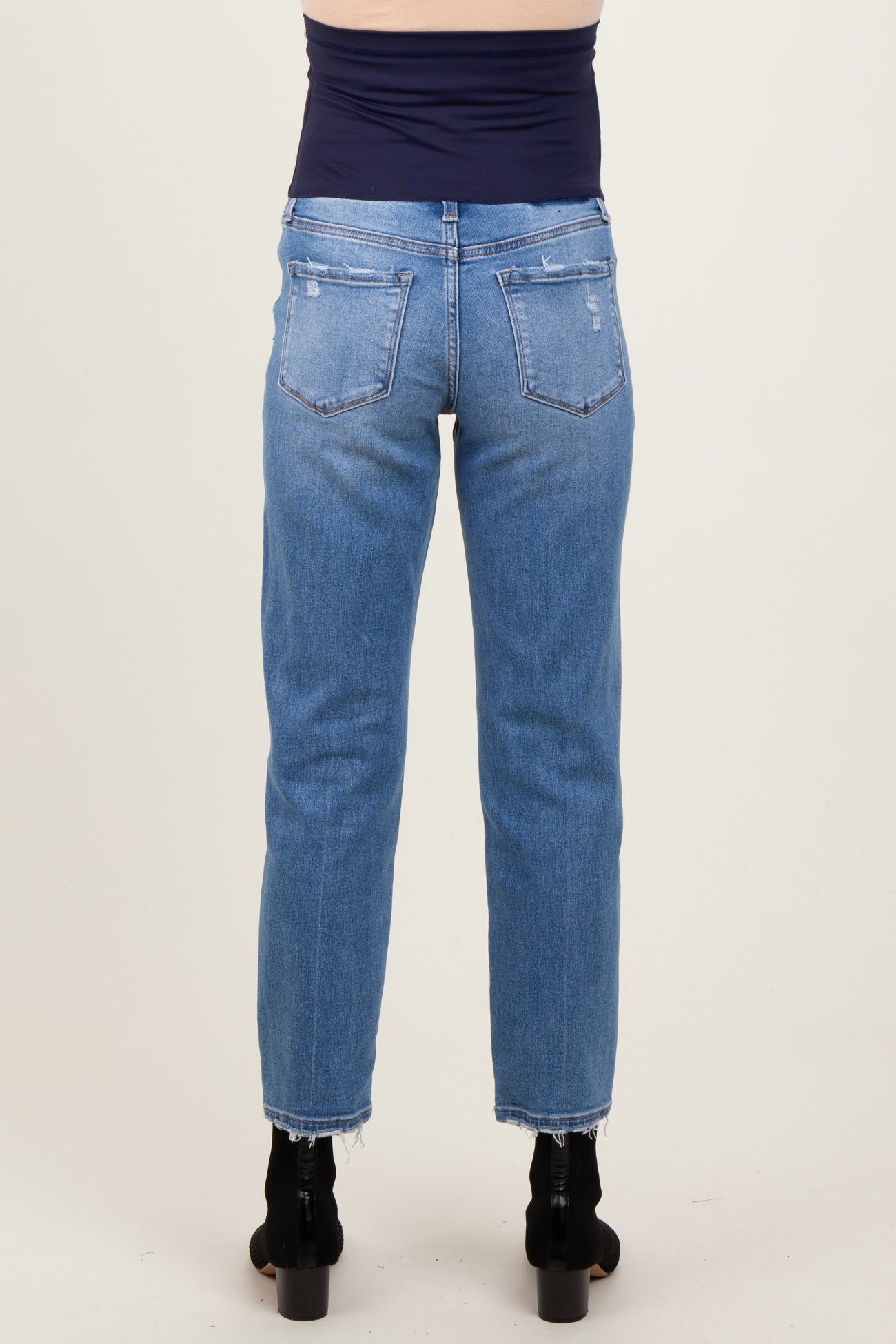 maternity wear light wash straight leg jeans with a raw hem, model shown from the back