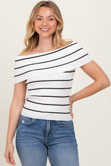 woman wearing a white and black striped off-the-shoulder top with ribbed detailing and blue jeans