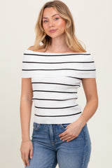 woman wearing a white and black striped off-the-shoulder top with a fitted style and blue jeans
