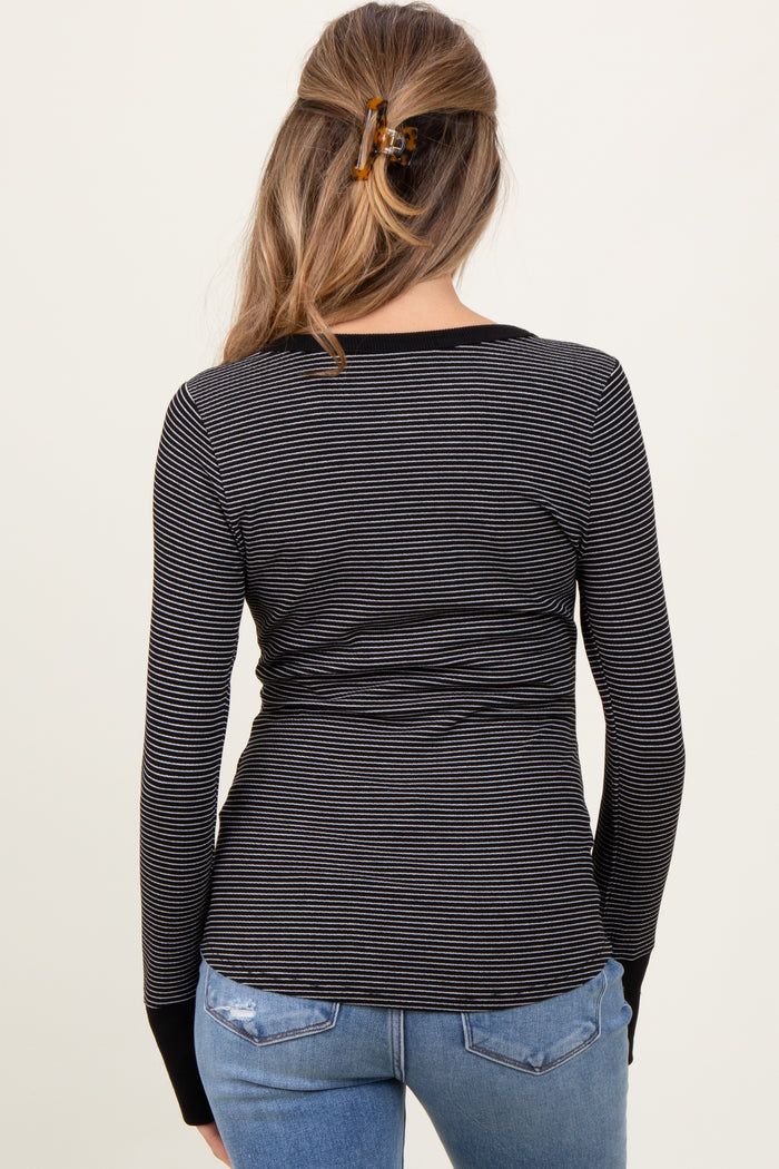 woman wearing a black and white striped maternity long sleeve top with a fitted style and back view showing a baby bump