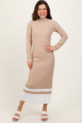 woman wearing a beige ribbed long sleeve midi dress with white stripes at the hem and smiling