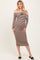 woman wearing a brown and cream striped off-the-shoulder maternity dress with a fitted silhouette and flower detail