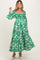 woman wearing a green floral maternity dress with puff sleeves and a smocked bodice, showcasing her baby bump