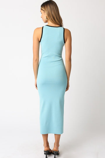 woman wearing a light blue ribbed midi dress with black straps, shown from the back