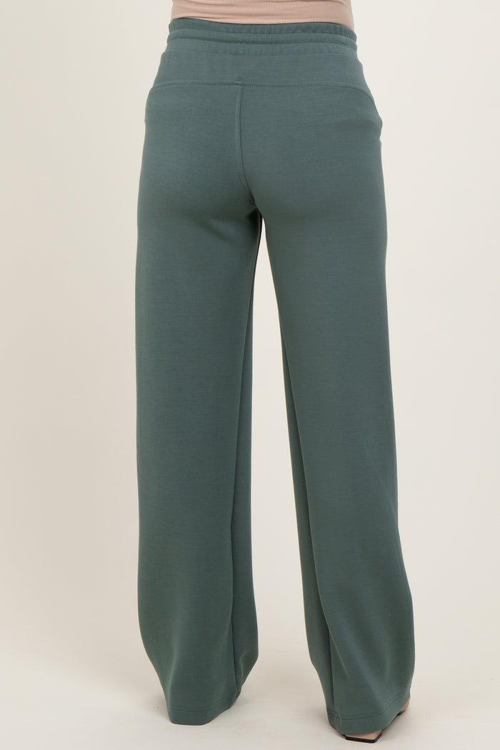 maternity wear in soft green wide-leg sweatpants, shown from the back with a comfortable fit