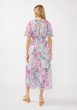 woman wearing a floral print maxi dress with short sleeves and a tie at the waist, showing a slight back opening