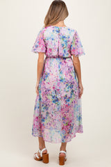 maternity wear floral maxi dress with short flutter sleeves and a cinched waist, model seen from the back