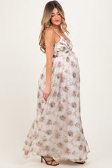 woman wearing a flowy floral maternity maxi dress with a baby bump visible