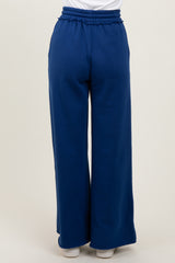 woman wearing navy blue wide leg pants with an elastic waistband, viewed from the back