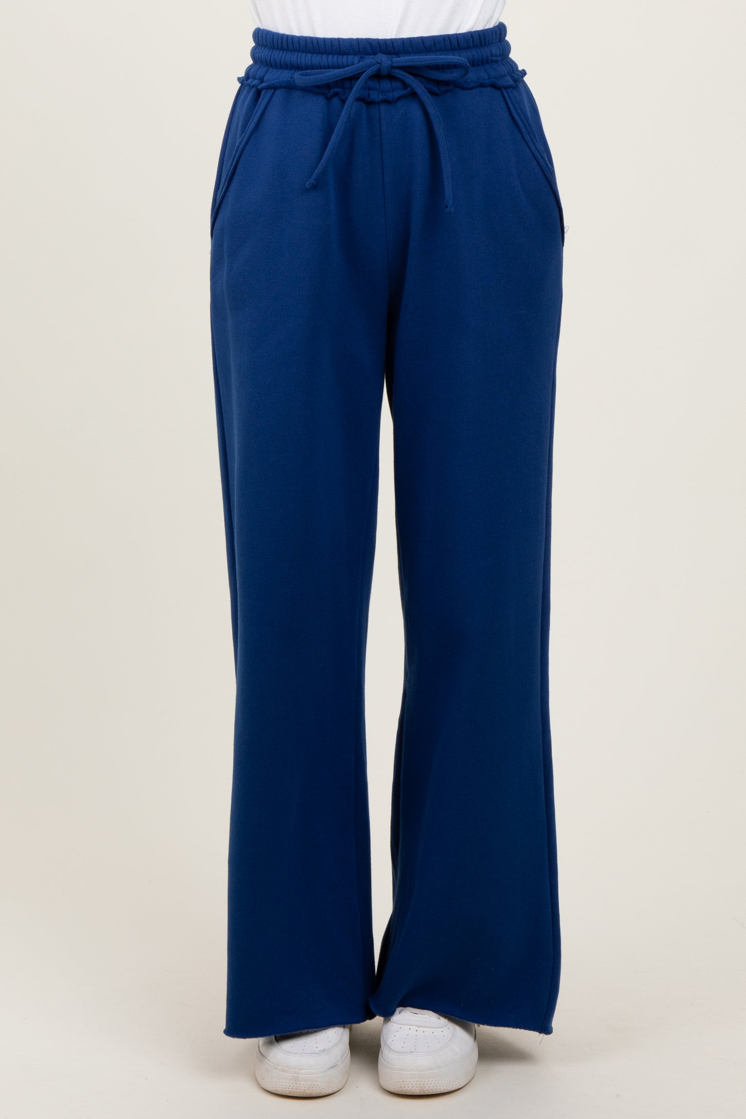 woman wearing blue wide-leg lounge pants with an elastic waistband and side pockets