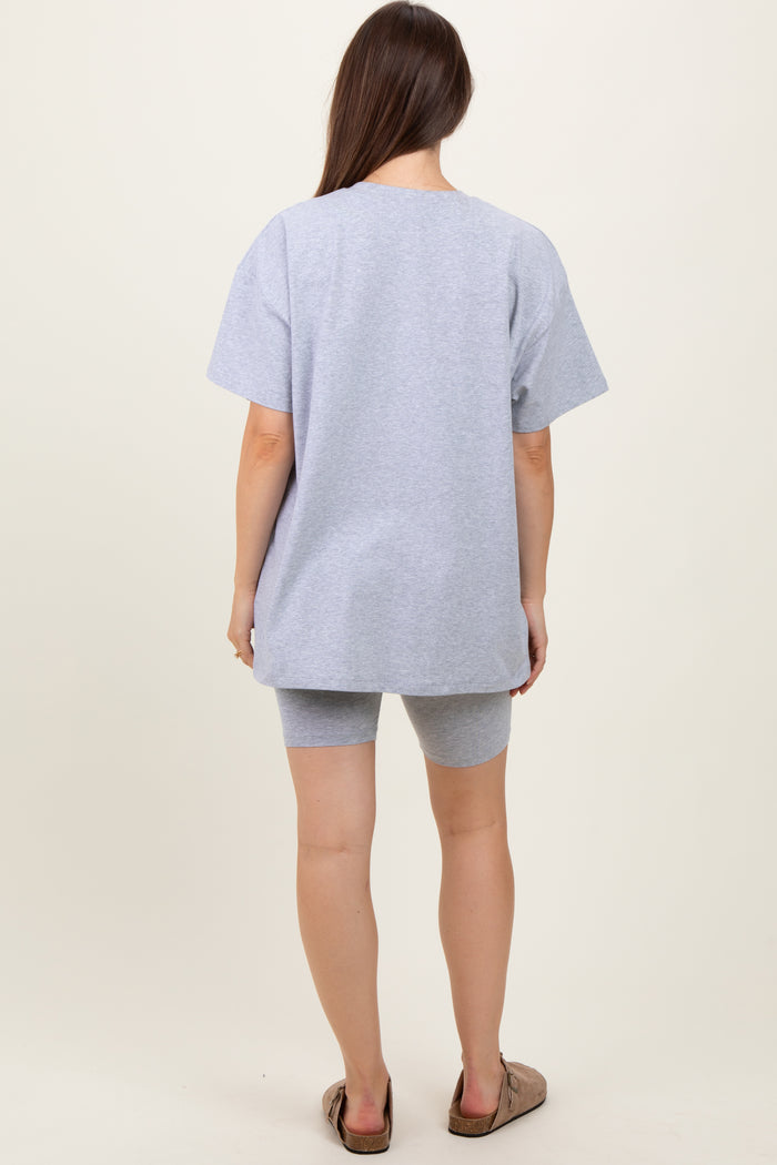 woman wearing a gray oversized t-shirt paired with matching shorts, showing a relaxed maternity style