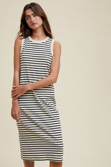 woman wearing a black and white striped sleeveless midi dress with a relaxed fit