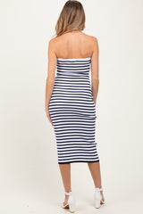 woman wearing a navy and white striped maternity dress that is fitted and knee-length without sleeves