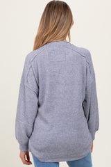 woman wearing a gray long sleeve maternity sweater with a relaxed fit and ribbed texture, showing the back view