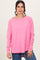 woman wearing a bright pink long sleeve top with a relaxed fit and raw edging details